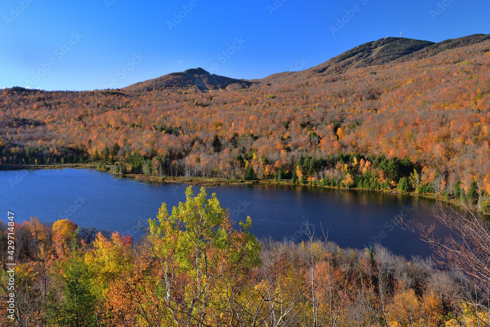 Orford National Park SEPAQ, Cherry pond during fall season, autumn colors, Orford and Giroux Mounts background