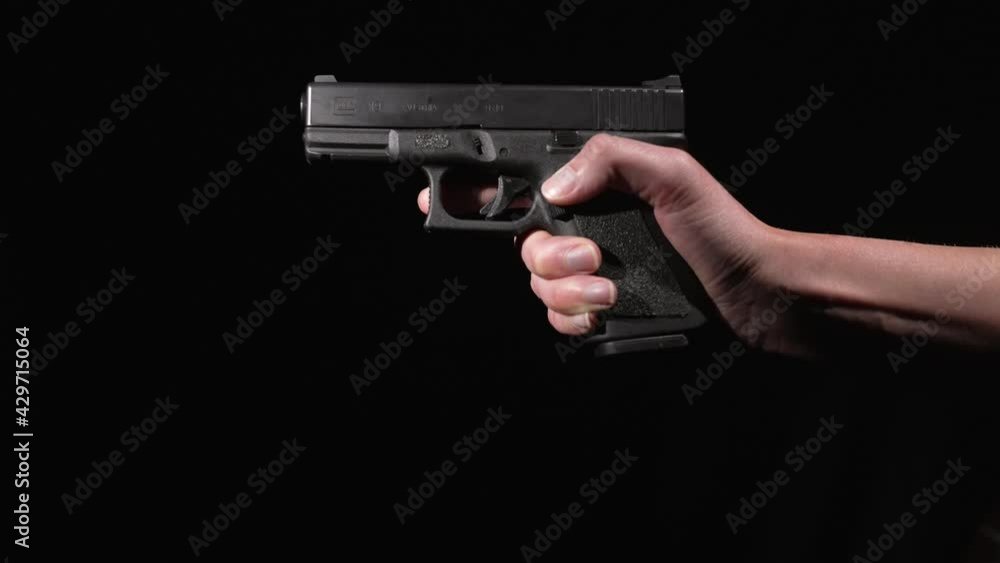 This video shows hands inserting and locking in a new magazine clip of bullets into a 9mm gun. This video shows hands inserting and locking in a new magazine clip of bullets into a 9mm gun.