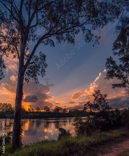 Vertical Shot of Riverside Sunset with Cloud Reflections