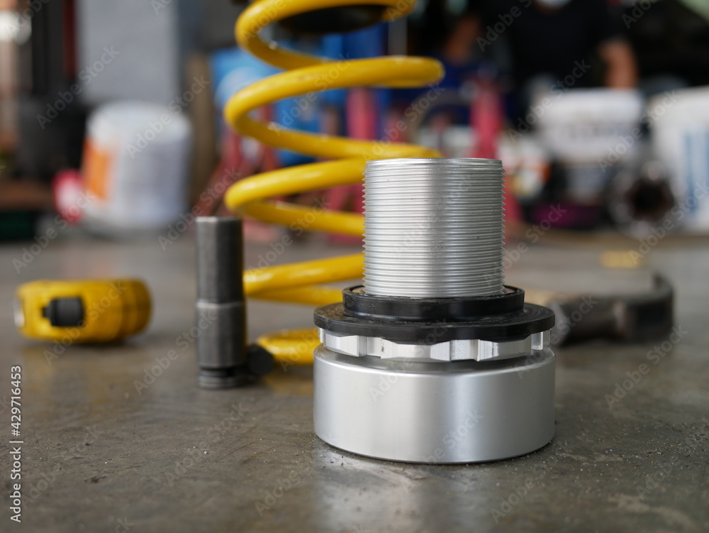 maintaining a car shock absorbers at repair service station. maintaining a car shock absorbers at repair service station.