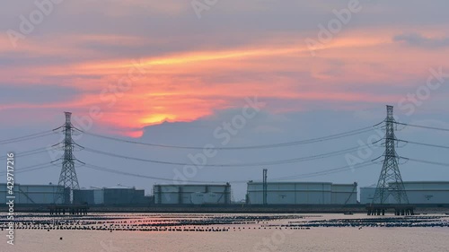 TL Oil tanks petroluem storae tanks alongside sea in sunset photo