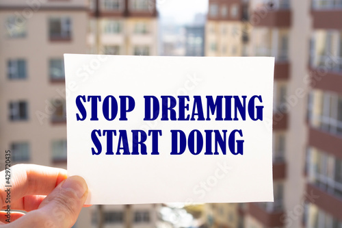 Text sign showing Stop Dreaming Start Doing