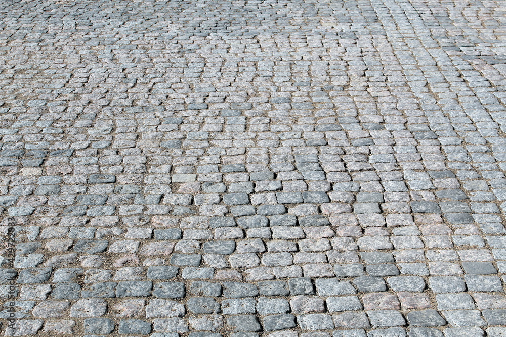 Ancient sidewalk lined with small natural stones Ancient sidewalk lined with small natural stones