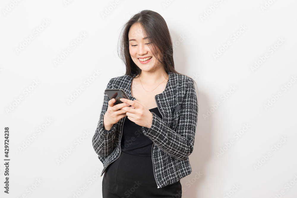 Portrait of Asian woman using mobile phone application and pointing finger to smartphone isolated over white background. Portrait of Asian woman using mobile phone application and pointing finger to smartphone isolated over white background.