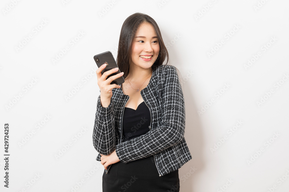 Portrait of Asian woman using mobile phone application and pointing finger to smartphone isolated over white background. Portrait of Asian woman using mobile phone application and pointing finger to smartphone isolated over white background.