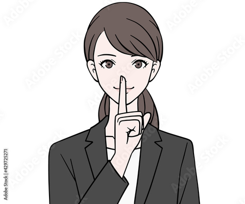 人差し指を口に当てるスーツの女性