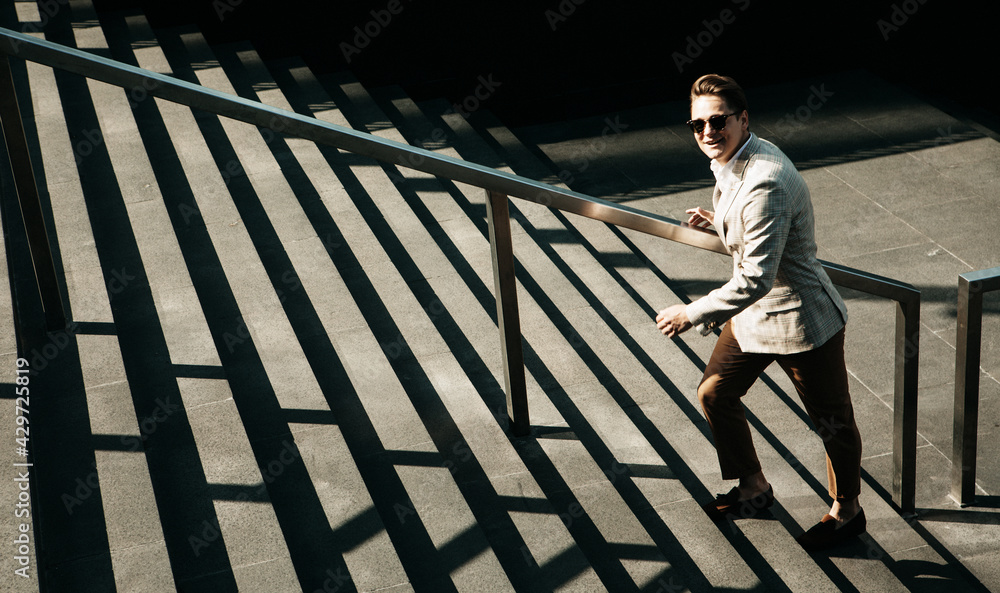 Business and people concept: Young Business man going up the stairs