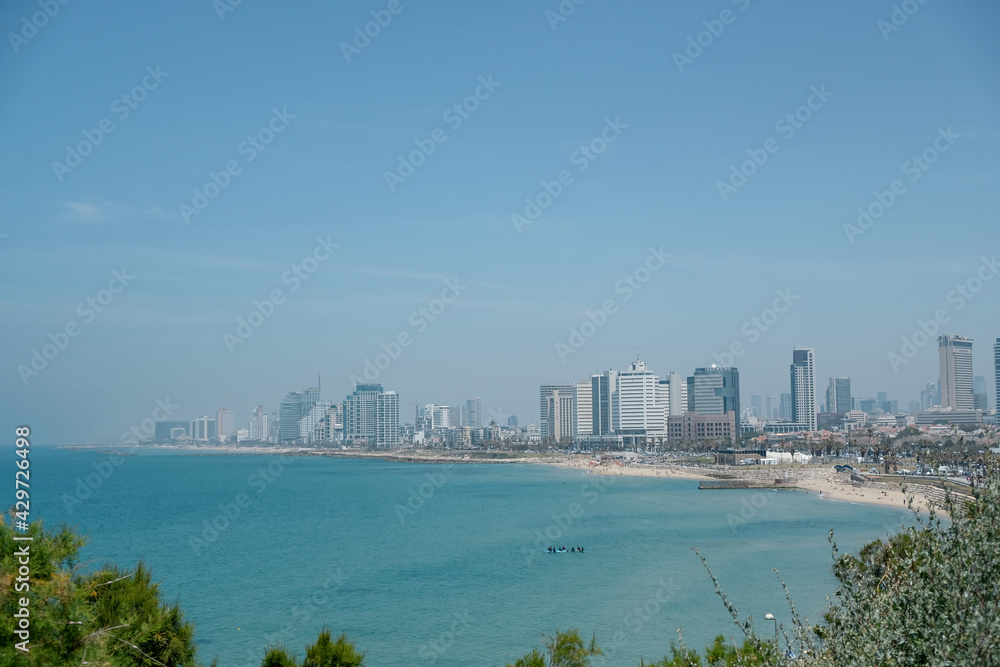 Tel-Aviv city in blur background. Air pollution. Blurred dust. Big city with skyscrapers. Tel-Aviv city in blur background. Air pollution. Blurred dust. Big city with skyscrapers.