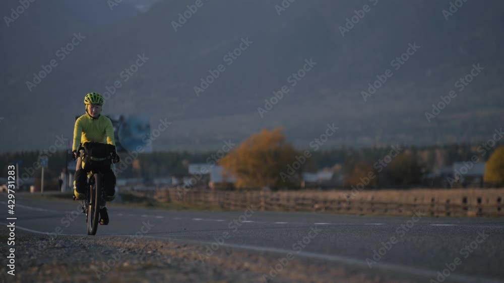 The woman travel on mixed terrain cycle touring with bikepacking. The traveler journey with bicycle bags. Sport tourism bikepacking. The woman travel on mixed terrain cycle touring with bikepacking. The traveler journey with bicycle bags. Sport tourism bikepacking.