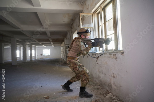 soldier in action near window changing magazine and take cover © .shock