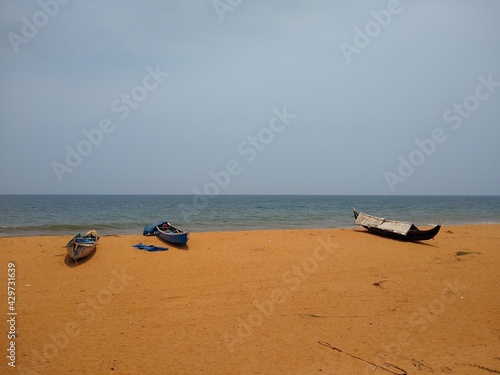 Fototapeta Naklejka Na Ścianę i Meble -  fishing boats on the seashore, seascape view, Thiruvananthapuram Kerala