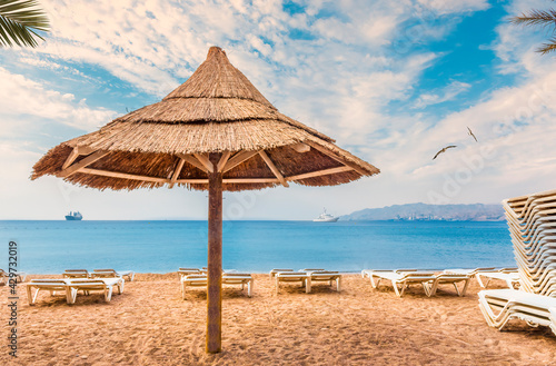 Morning on sandy beach of the Red Sea in Eilat - famous tourist resort and recreational city in Israel and Middle East
