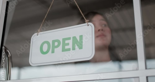 Young woman truning hang signboard with closed word photo