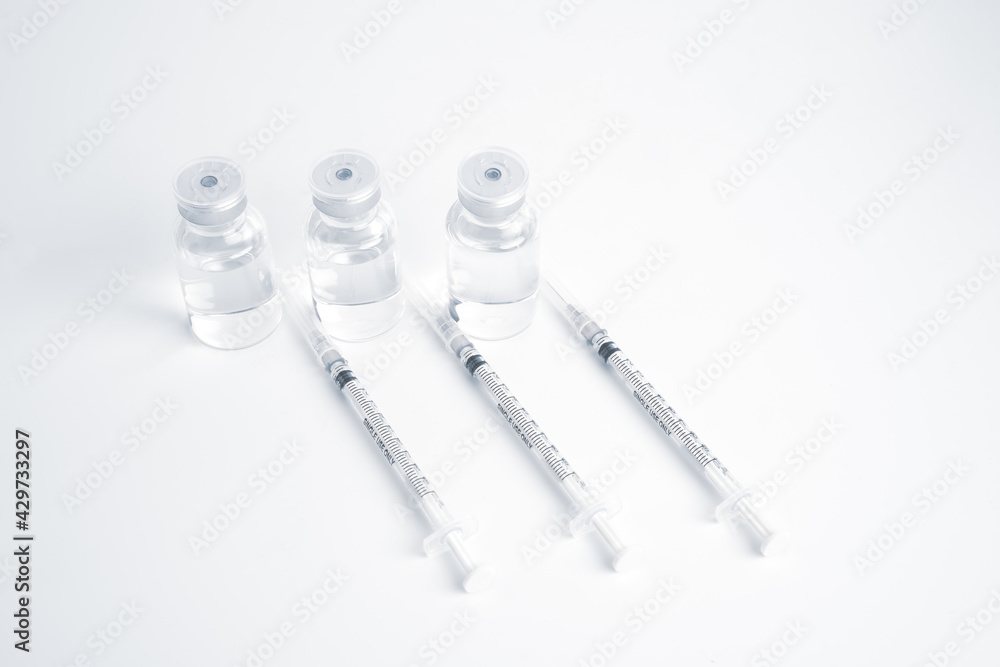 Empty bottle of vaccine with syringe for hygiene injection. Pharmaceutical equipment protective infection of pandemic covid-19 virus, flu, disease. Isolated on white background, copy space. Empty bottle of vaccine with syringe for hygiene injection. Pharmaceutical equipment protective infection of pandemic covid-19 virus, flu, disease. Isolated on white background, copy space.