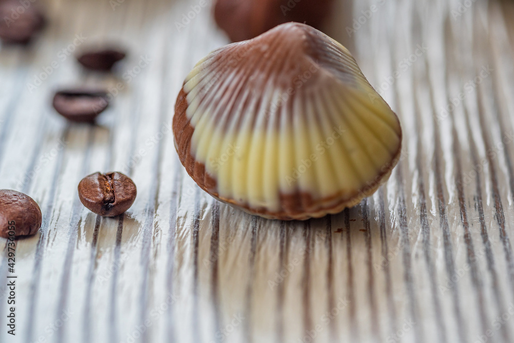 Figures of Belgian chocolate on a light wooden background close-up. Figures of Belgian chocolate on a light wooden background close-up.