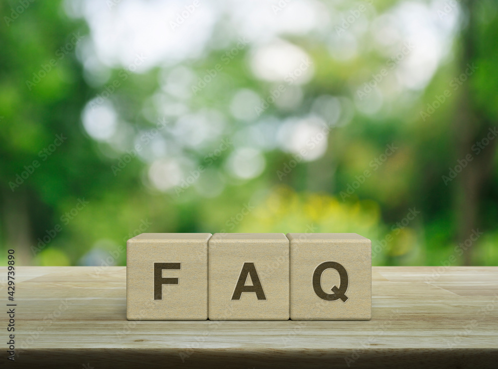 FAQ letter on block cubes on wooden table over blur green tree in park, Frequently asked questions, Business customer service and support concept - obrazy, fototapety, plakaty 