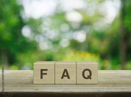 фотографія FAQ letter on block cubes on wooden table over blur green tree in park, Frequent