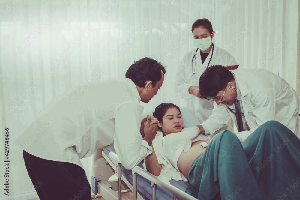 Concept of taking care of the antenatal care of doctors : Male doctors, pediatricians care for health, pregnant women and fetus for healthy, ready to give birth to a baby in the womb. Concept of taking care of the antenatal care of doctors : Male doctors, pediatricians care for health, pregnant women and fetus for healthy, ready to give birth to a baby in the womb.
