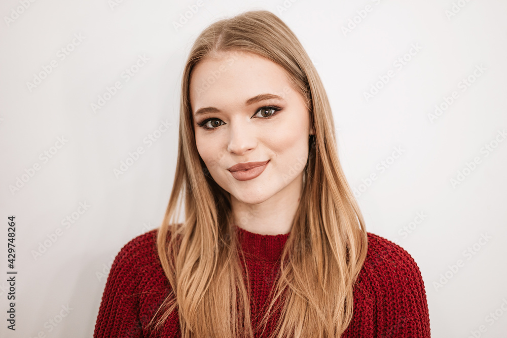 beautiful young blonde woman with a beautiful evening makeup stands in a beauty salon on white background beautiful young blonde woman with a beautiful evening makeup stands in a beauty salon on white background