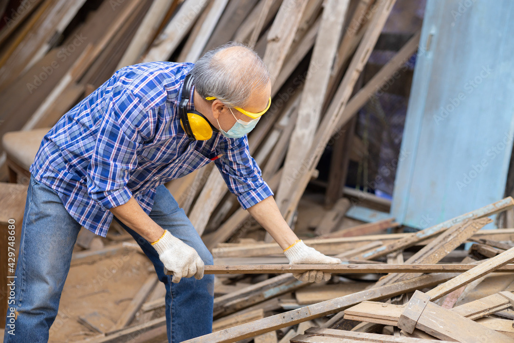 Elder worker wood woodcraft retire hobby for good retirement, Asian male mature professional master of making wooden furniture with face mask protective. Elder worker wood woodcraft retire hobby for good retirement, Asian male mature professional master of making wooden furniture with face mask protective.