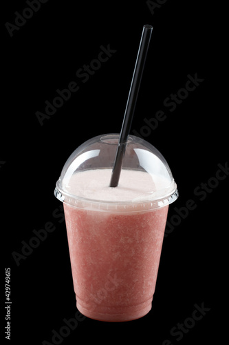 Milkshake with ice cream, juice and fruit syrup, closed glass, black background, isolate