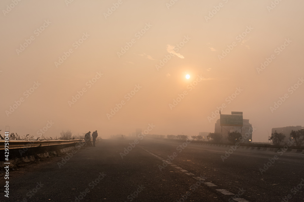 Indian Road Highways, Beautiful landscape of Indian roads during fog and sunrise in winter morning. Vehicles running on highways. Indian Road Highways, Beautiful landscape of Indian roads during fog and sunrise in winter morning. Vehicles running on highways.