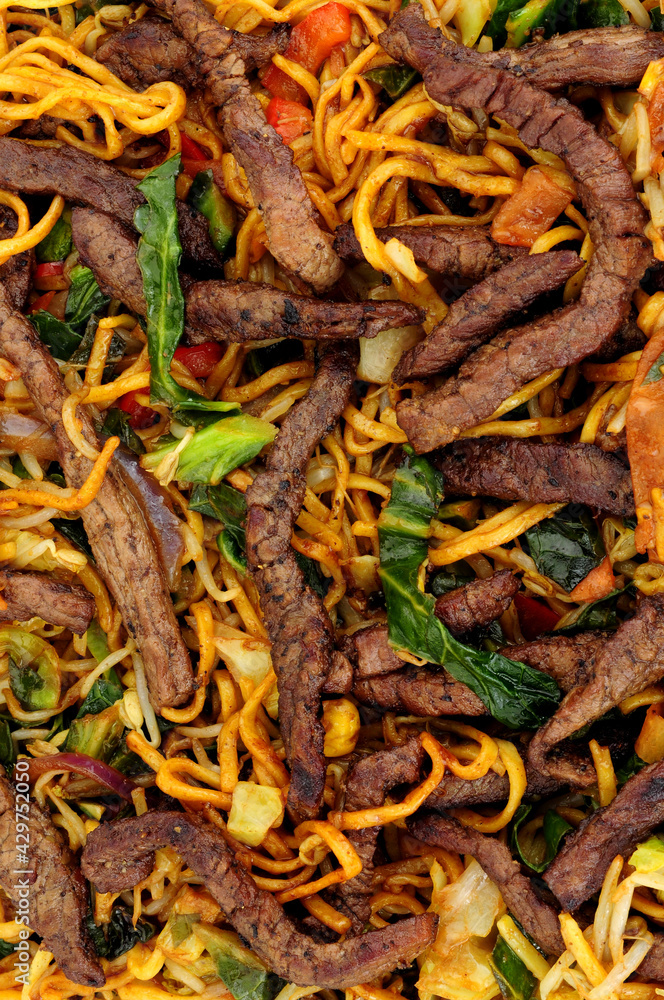 Beef and egg noodle stir fry with vegetables background Beef and egg noodle stir fry with vegetables background