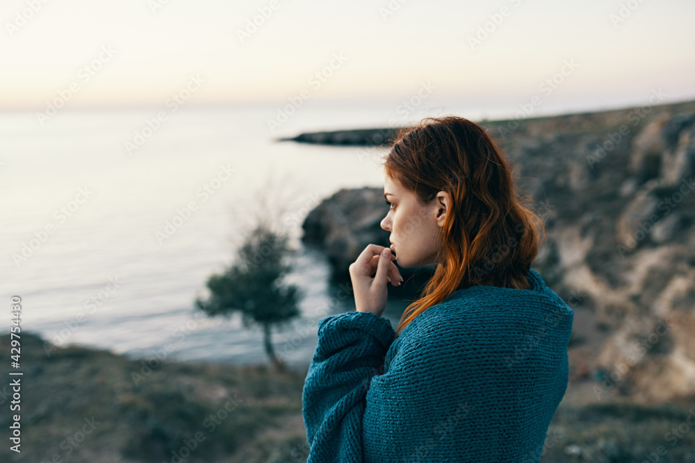 woman in the mountains with a blue plaid on her shoulders landscape nature sunset