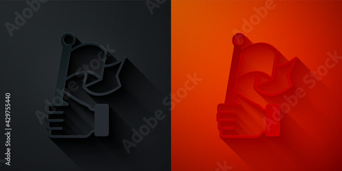 Paper cut Hand holding flag icon isolated on black and red background. Victory, winning and conquer adversity concept. Paper art style. Vector