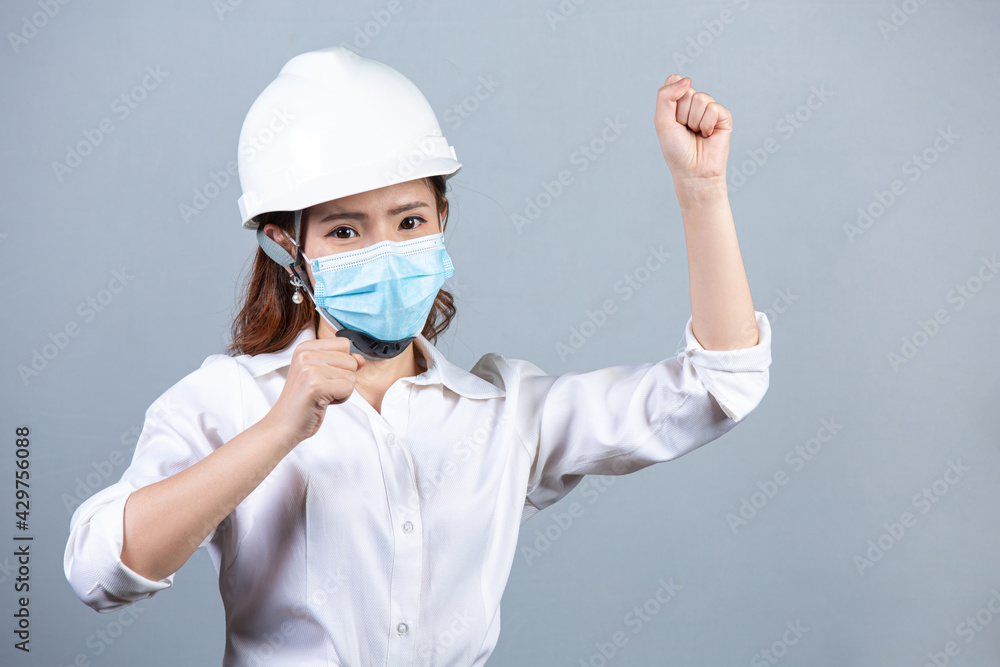 Portrait of young beautiful business woman wearing face mask on gray backgroud Portrait of young beautiful business woman wearing face mask on gray backgroud