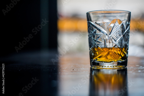 Fotografija Whisky glass on a wooden surface