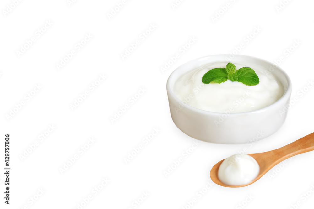 Yogurt in ceramic bowl with mint leaf and wooden spoon, Isolated on white background with copy space, Milk curd organic homemade, Processed dairy products for Health care and Healthy food concept. Yogurt in ceramic bowl with mint leaf and wooden spoon, Isolated on white background with copy space, Milk curd organic homemade, Processed dairy products for Health care and Healthy food concept.