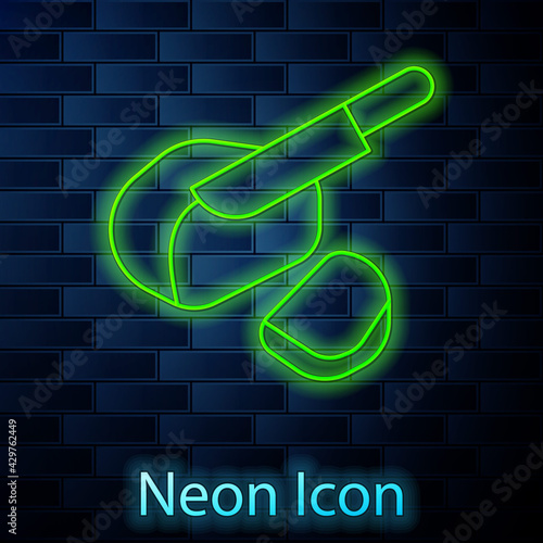 Glowing neon line Canadian peameal bacon icon isolated on brick wall background. Vector