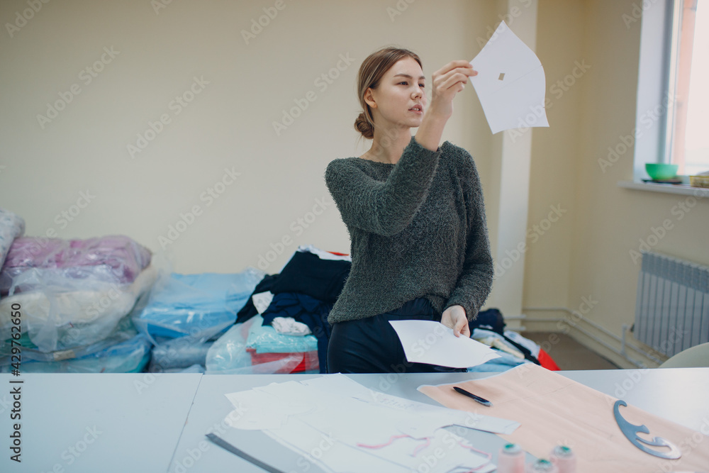 Clothing designer with pattern and template in cloth fabric factory Clothing designer with pattern and template in cloth fabric factory