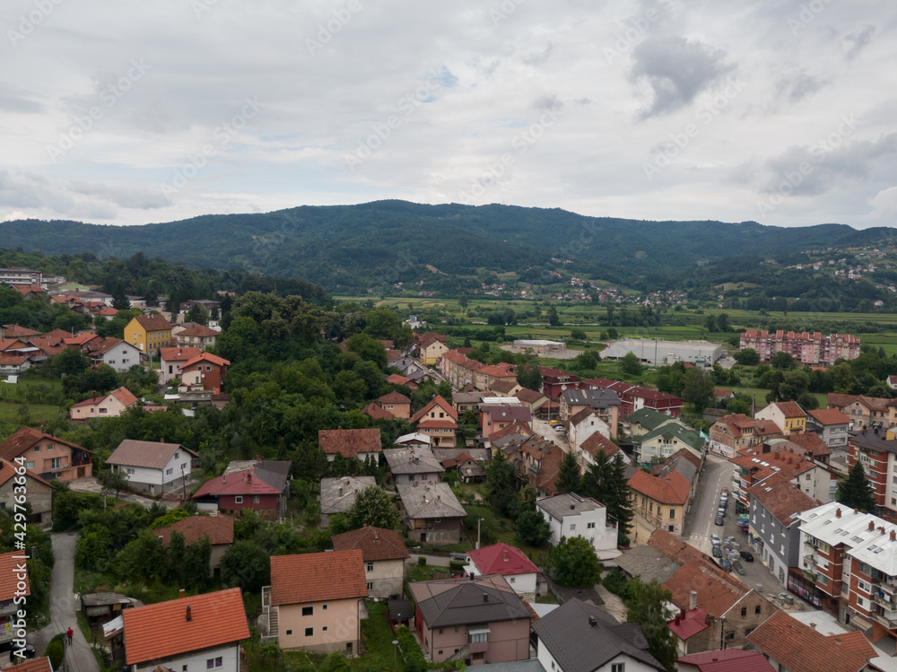 Aerial view of Doboj and hilly countryside from medieval fortress Gradina during overcast summer day.