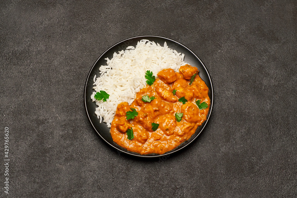 Plate of Traditional Chicken Curry and rice on dark concrete background Plate of Traditional Chicken Curry and rice on dark concrete background