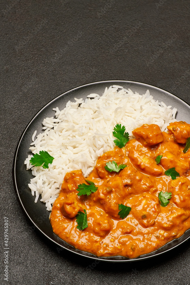 Plate of Traditional Chicken Curry and rice on dark concrete background Plate of Traditional Chicken Curry and rice on dark concrete background