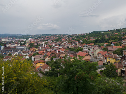 Aerial view of Doboj hilly suburbs from medieval fortress Gradina during overcast summer day.