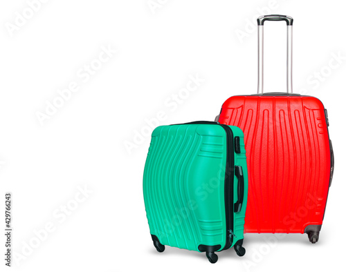 Colored suitcases on white background. Close up