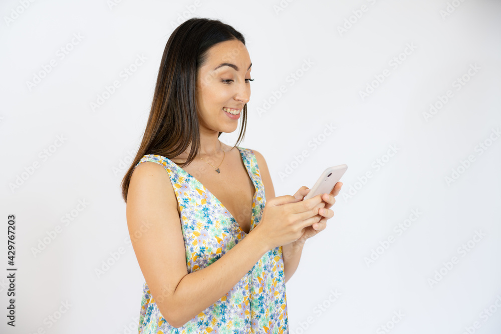 Cheerful young woman using a mobile phone isolated over white background Cheerful young woman using a mobile phone isolated over white background