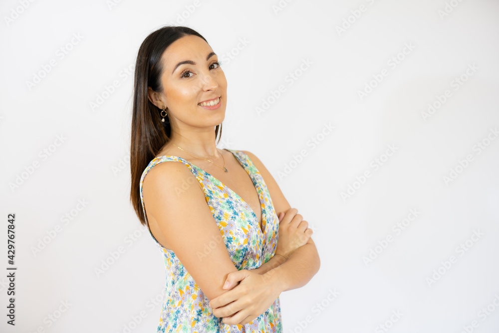 Young smiling woman with arms folded over white background Young smiling woman with arms folded over white background