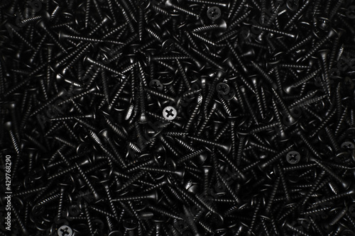 Many black metal screws. Flat lay frame