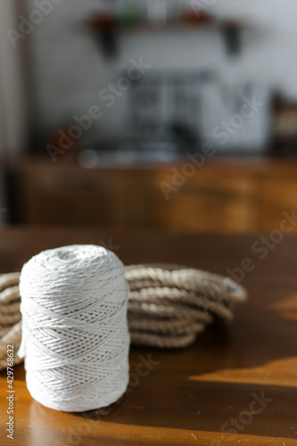 Handmade home decor made from organic jute fiber. Two wicker jute baskets are placed on a wooden table. jute rope and fiber. the concept of home decor and comfort in the eco style.