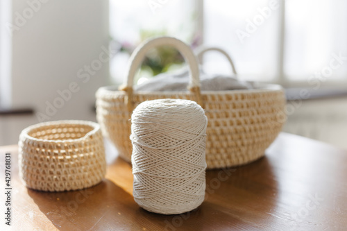 Handmade home decor made from organic jute fiber. Two wicker jute baskets are placed on a wooden table. jute rope and fiber. the concept of home decor and comfort in the eco style.