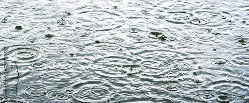 Raindrops and ripples on the water during heavy rain. 