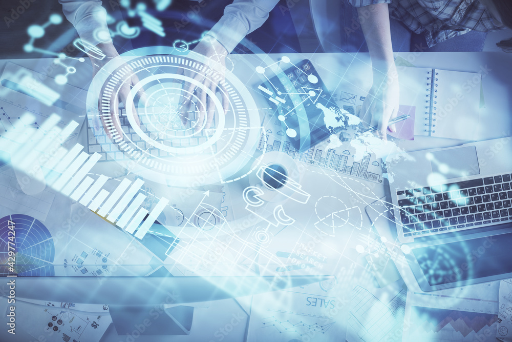 Double exposure of man and woman working together and business theme hologram drawing. Computer background. Top View. Double exposure of man and woman working together and business theme hologram drawing. Computer background. Top View.