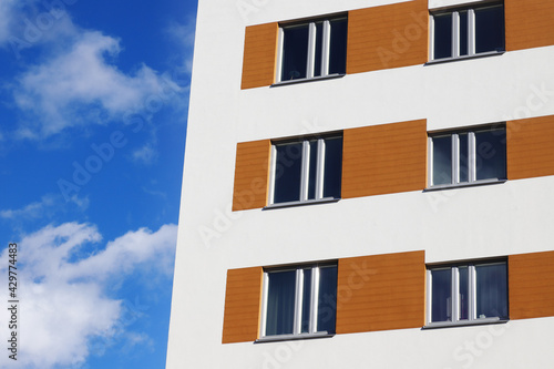 Close-up of modern residential mult-storey multi-family building constructed 2020 with shutter imitation,
