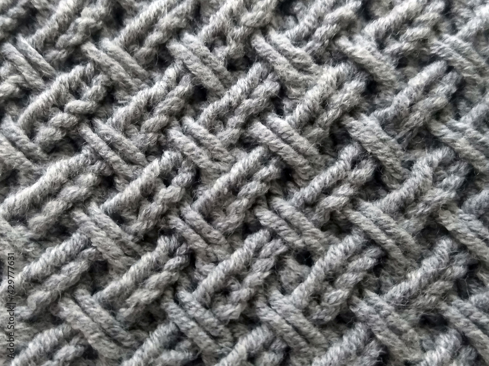 Handmade knitted fabric in gray with a diagonal pattern Handmade knitted fabric in gray with a diagonal pattern