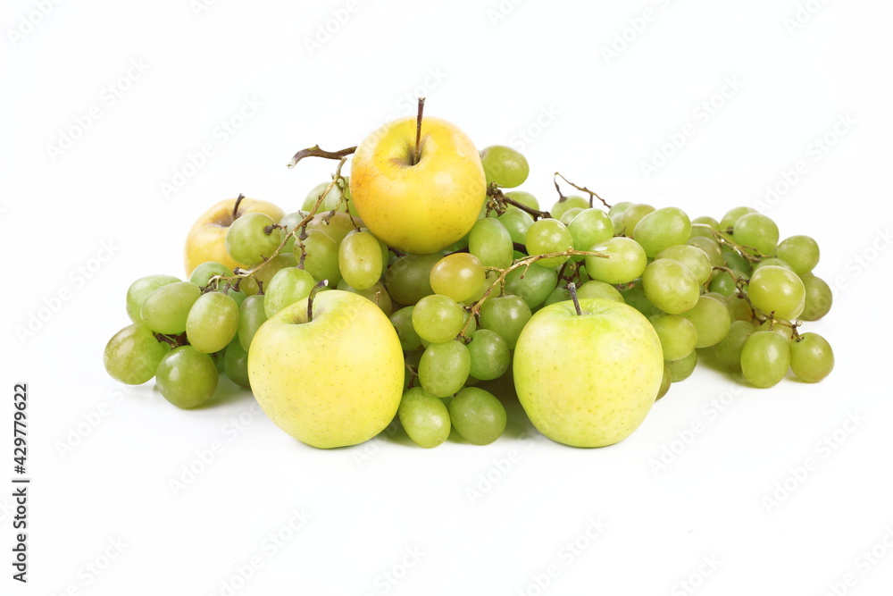 Still life with grapes and apples on a white background