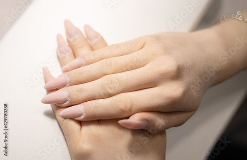 elegant female hands before procedure manicure in a beauty salon © klavdiyav